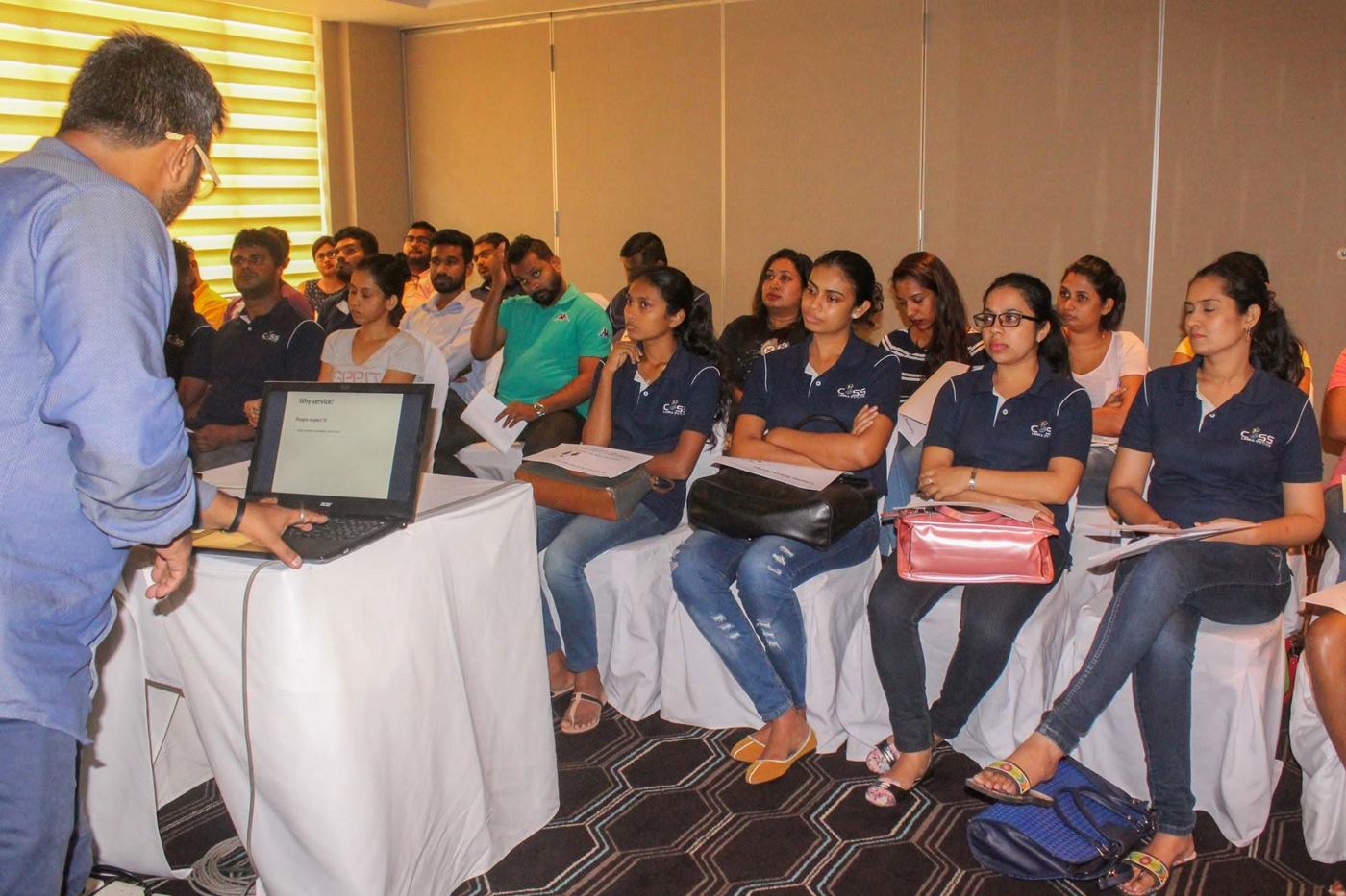 Arqam Azhar running a customer service workshop for a team